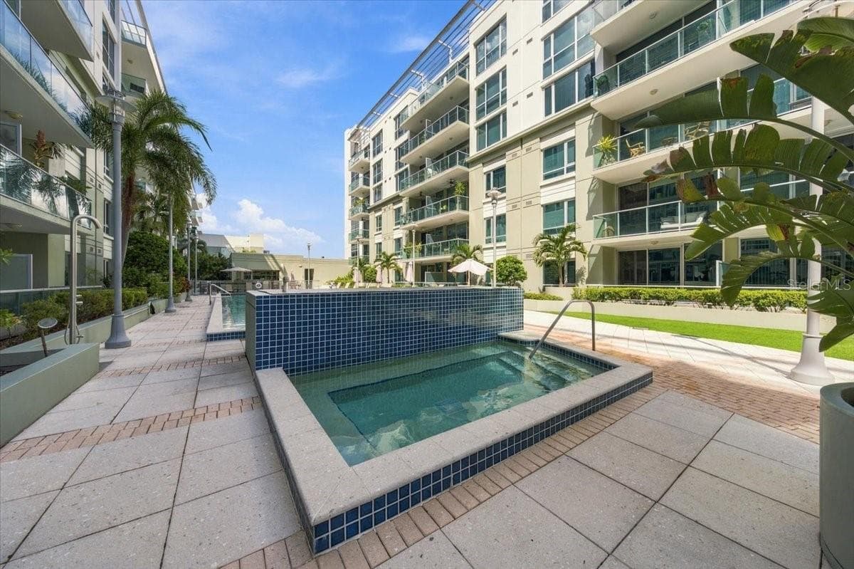 Relaxing outdoor spa and resort-style pool deck situated amidst tropical landscaping and modern residential architecture. - 111 N 12TH ST #1704, TAMPA