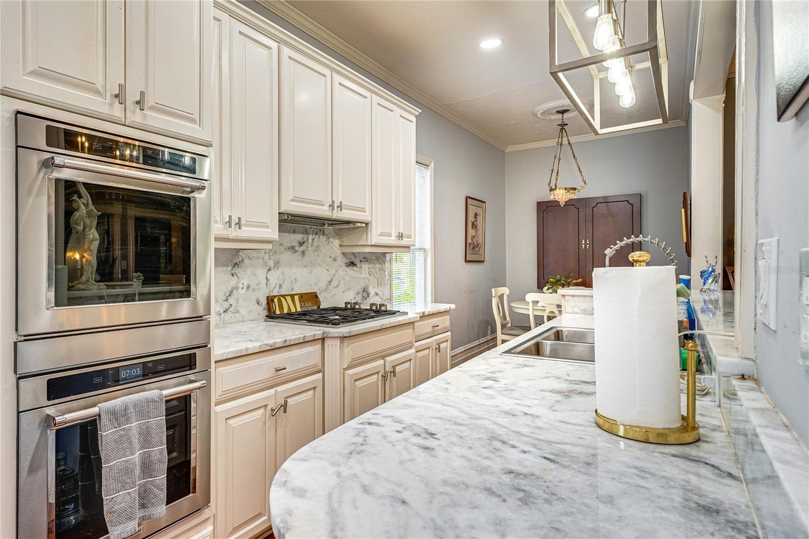 Kitchen with 1¼-Inch Granite Countertops and Double Ovens - 743 E FORT KING ST, OCALA