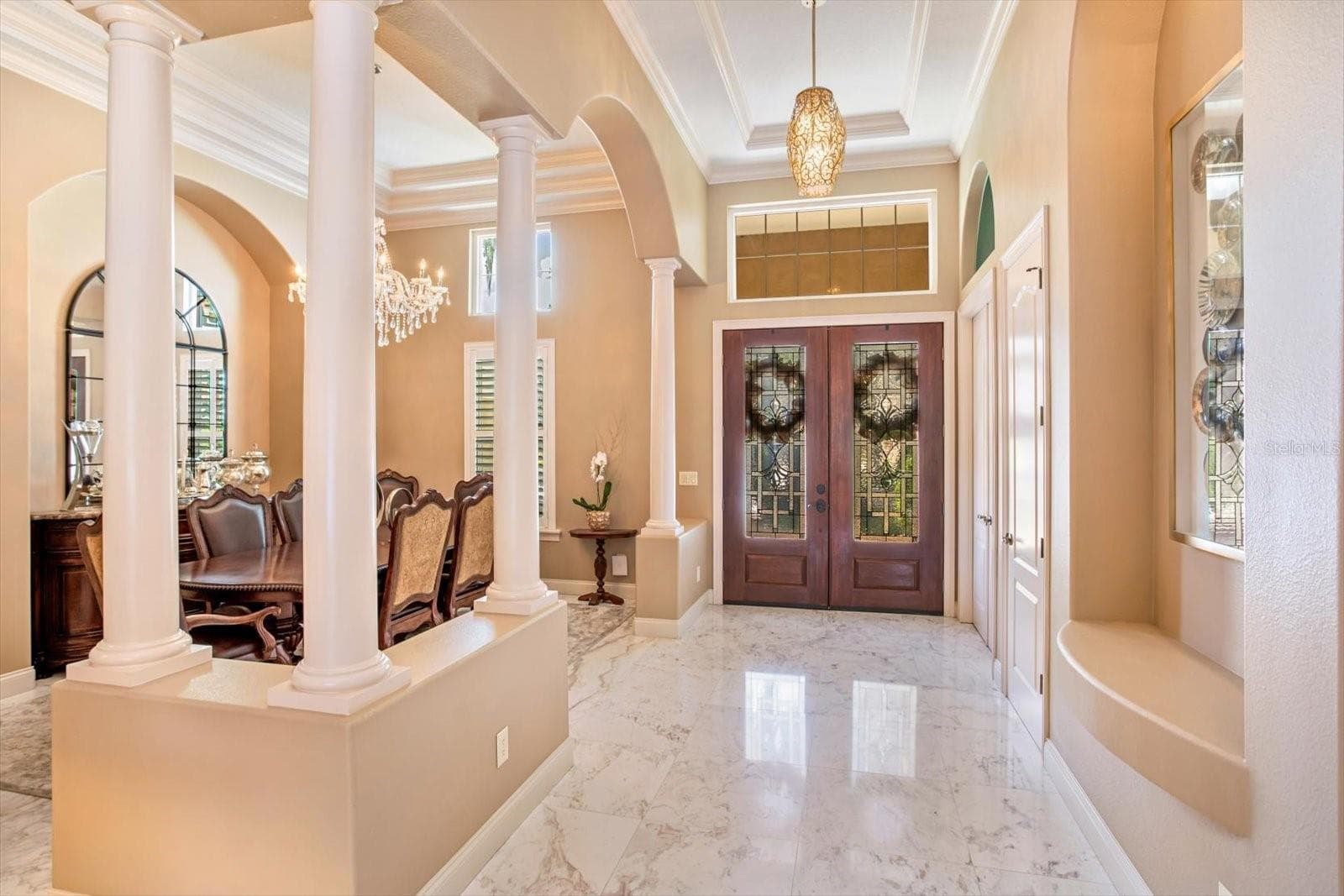 Updated Double-Front Doors with beveled glass inset and transom windows. Extended and wide foyer showcases the marble flooring in the living areas. - 1220 PRESTIGE PT, OVIEDO
