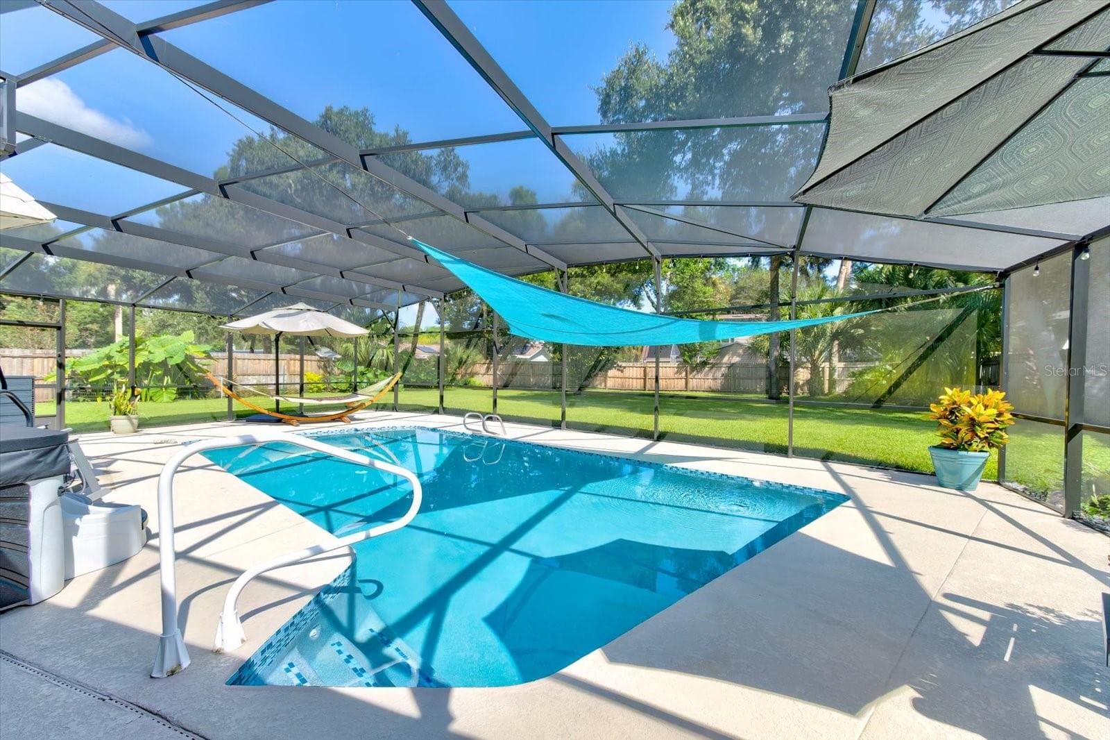 Private resurfaced pool with new tile, expanded deck, and new screened enclosure - 116 PARTRIDGE CIR, WINTER SPRINGS
