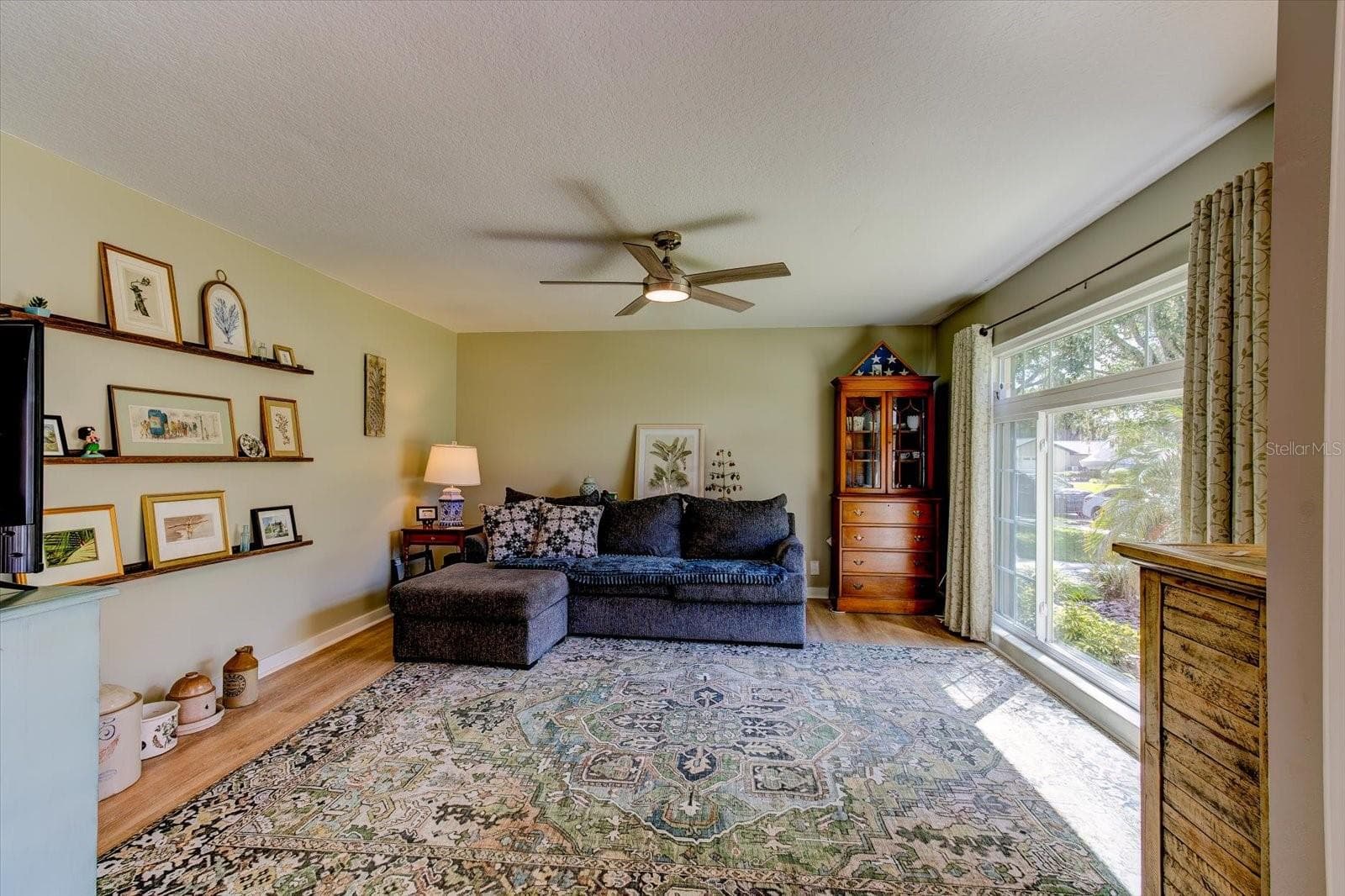 Natural light filled living room with views to front yard - 116 PARTRIDGE CIR, WINTER SPRINGS