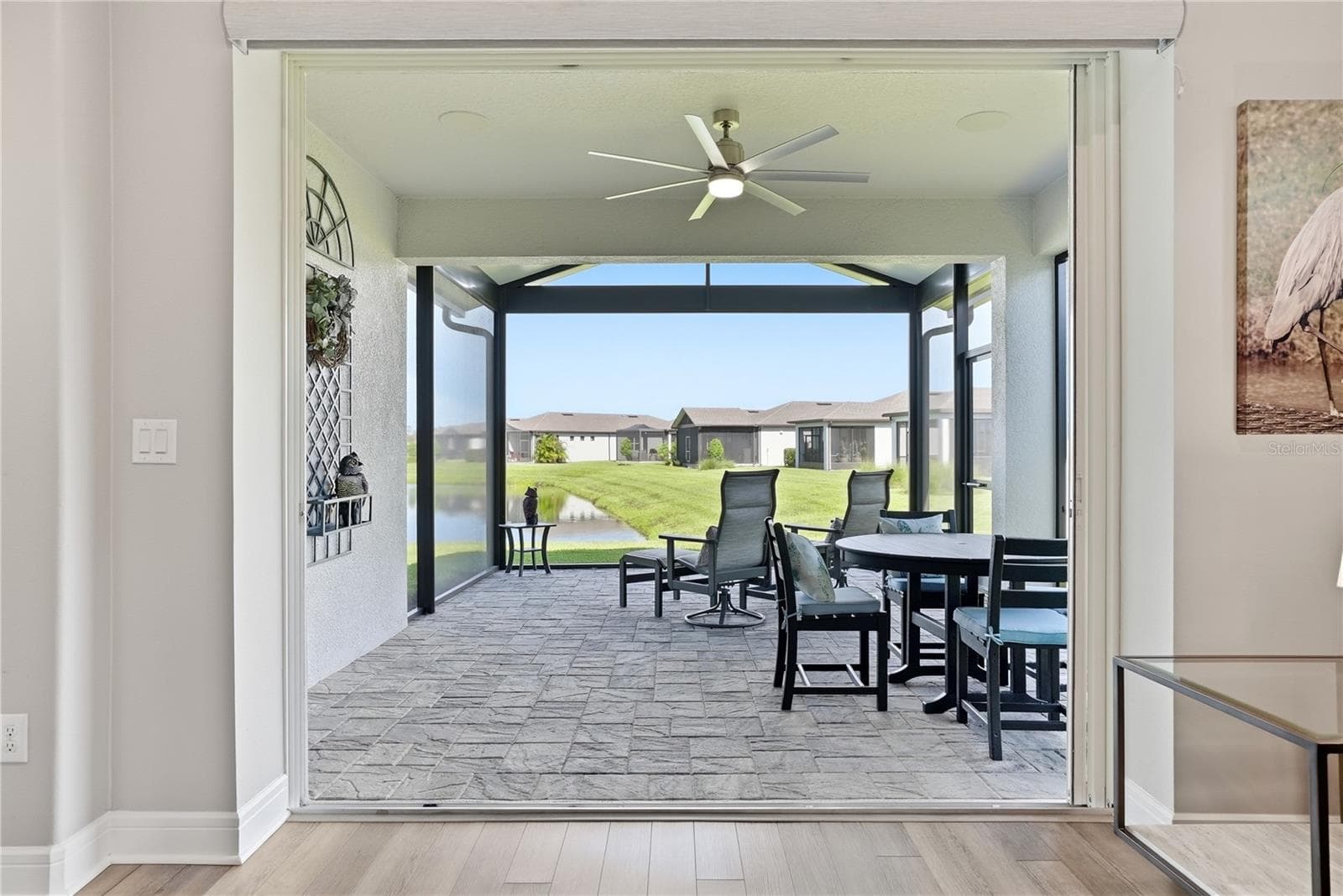 Relax in the covered and screened in lanai with a pond view. - 5535 BLUE CRUSH BND, LAND O LAKES