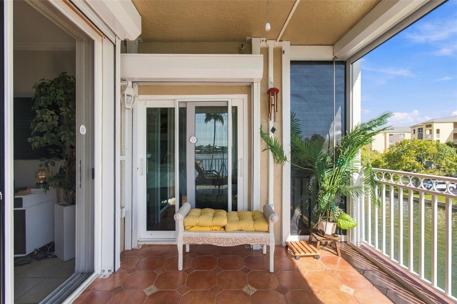 Balcony showing Hurricane shutters on sliding glass doors - 399 150TH AVE #205, MADEIRA BEACH