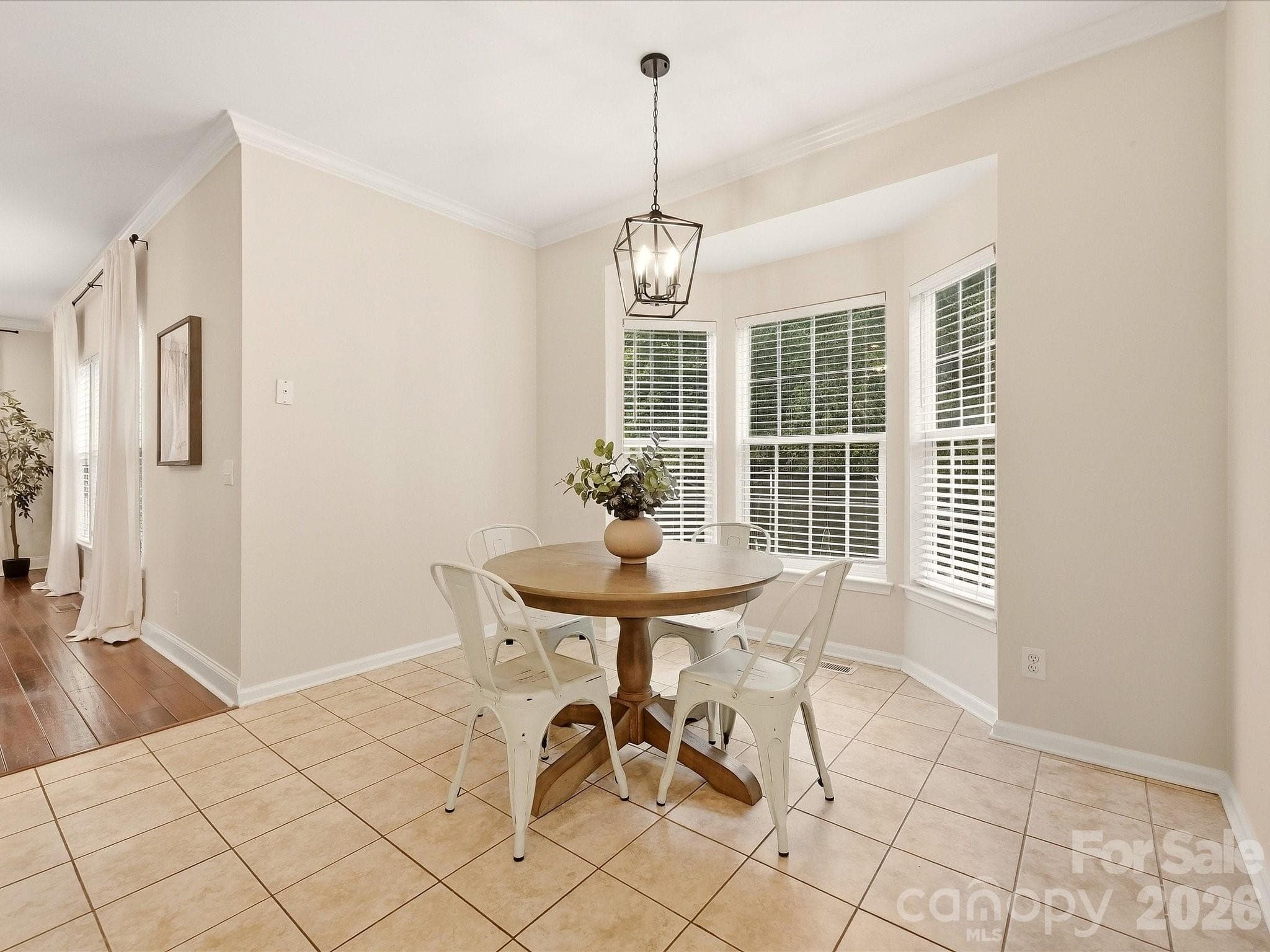The bright breakfast nook features a charming bay window, abundant natural light, and an easy connection to the kitchen for casual everyday dining. - 16006 Lavenham Road, Huntersville