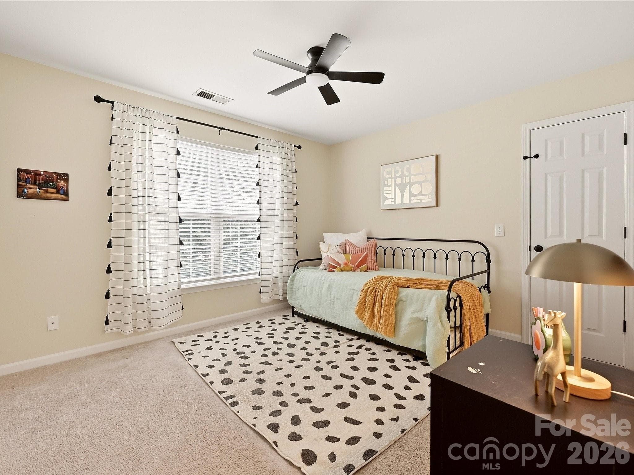 Bedroom 3 offers a bright, comfortable space with generous natural light, soft neutral finishes, and a ceiling fan for added comfort. - 16006 Lavenham Road, Huntersville