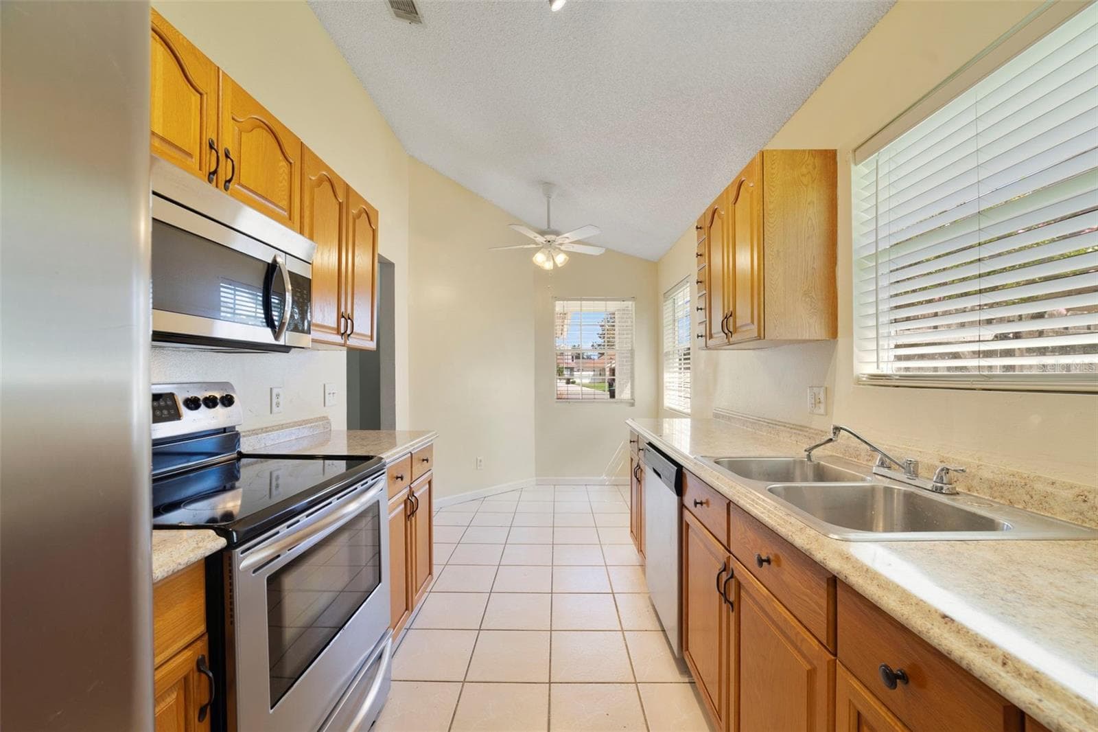 The Kitchen is conveniently located just off the main living spaces and features solid wood cabinetry, STAINLESS STEEL APPLIANCES, and a cozy, sunny BREAKFAST NOOK—a perfect spot for morning coffee or casual meals. - 713 MEADOWSIDE CT, ORLANDO