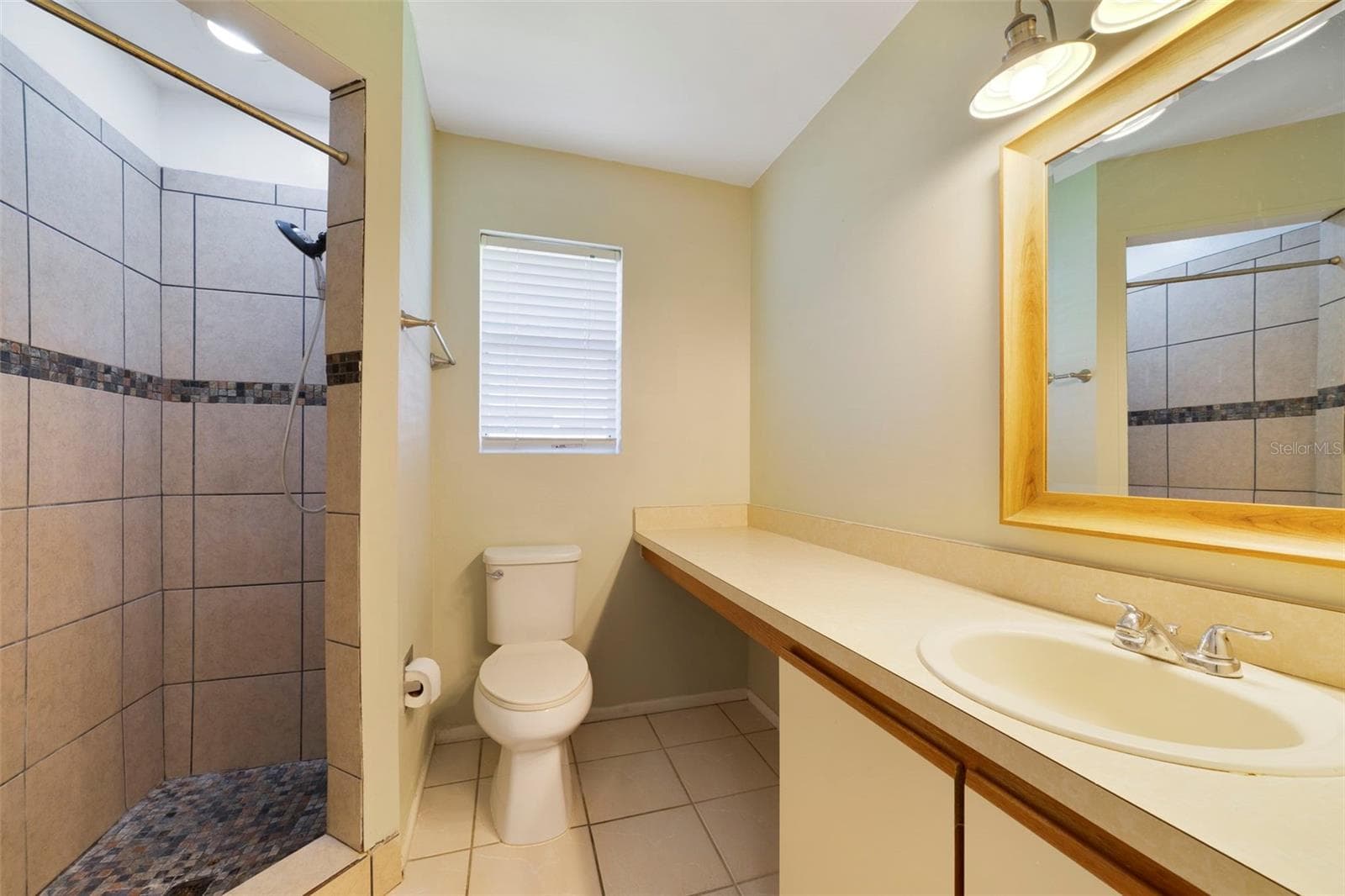 The Primary en-suite bath boasts a step-in shower, vanity with makeup space, and includes a LARGE WALK-IN CLOSET for convenient storage. - 713 MEADOWSIDE CT, ORLANDO