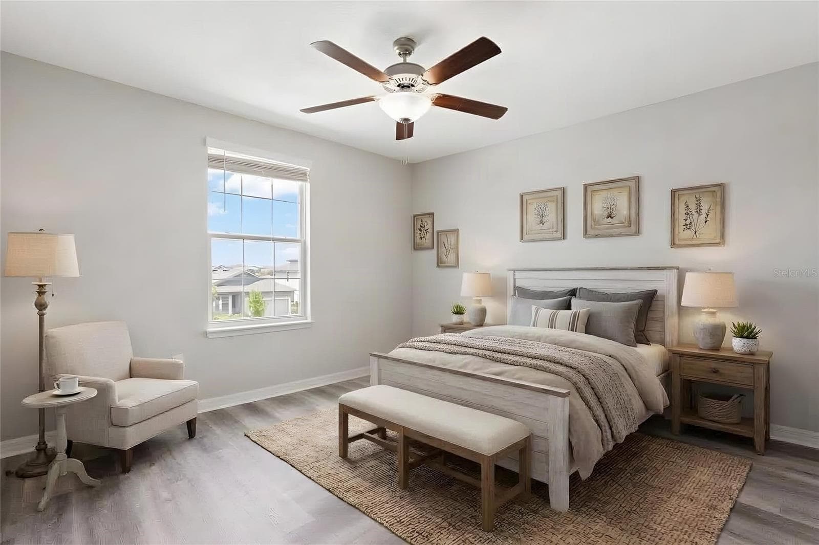 Bedroom 3 continues the clean, updated look with newly replaced laminate flooring, fresh neutral paint, a ceiling fan and a large window for natural light. - 5061 WHITE CHICORY DR, APOLLO BEACH