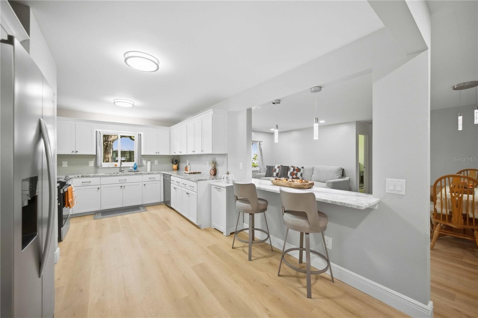 Spacious Kitchen with bar seating area overlooking living room - 8552 SW 92ND LN #C, OCALA
