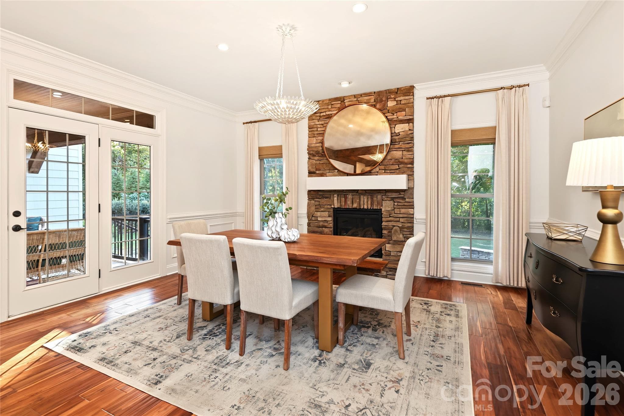 Enjoy family dinners by the fireplace or head out to the porch and sit by the fire. - 4934 Spalding Place, Charlotte