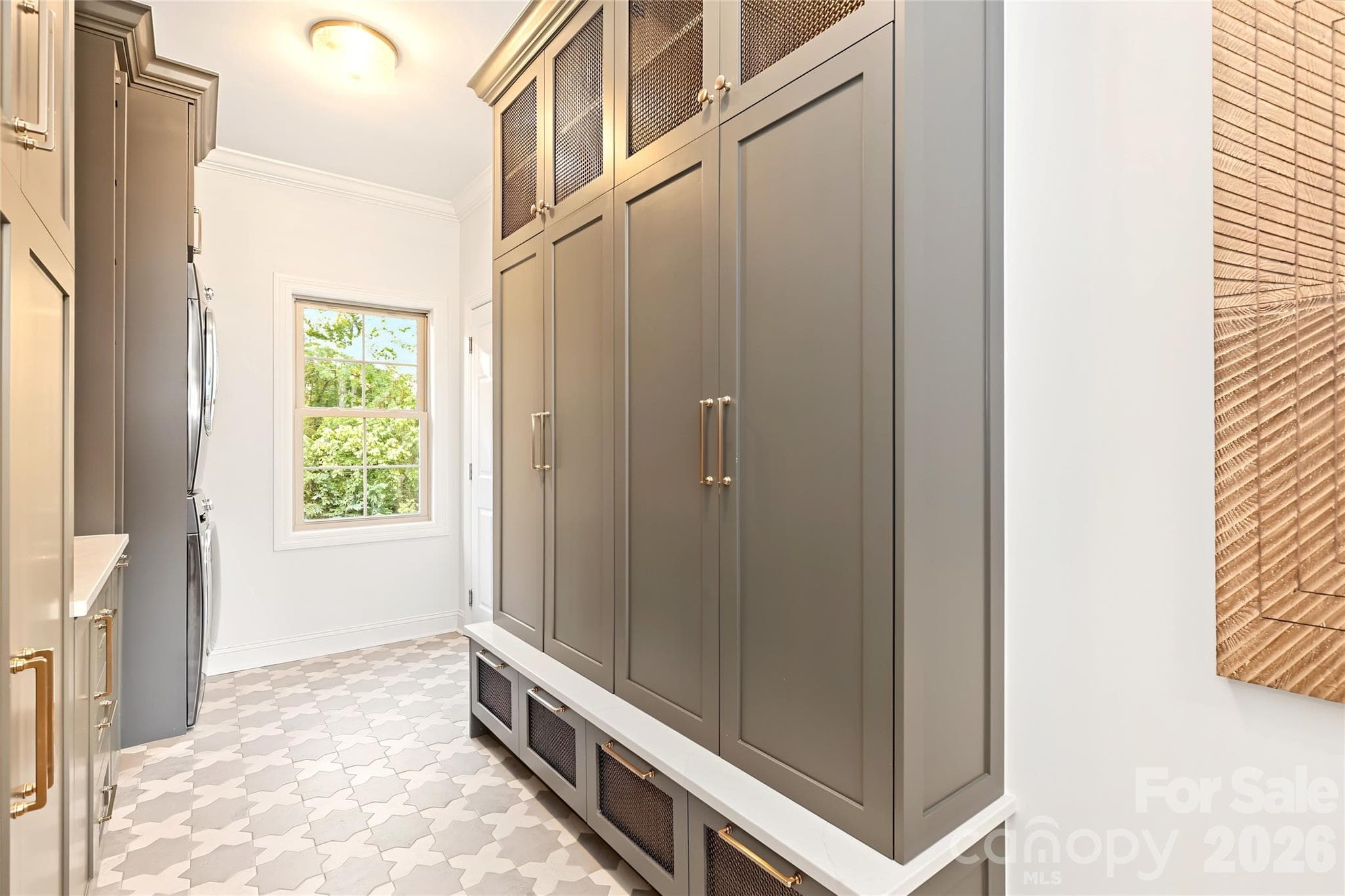 Laundry Room that leads out to the garage has tons of storage and built -ins! - 4934 Spalding Place, Charlotte