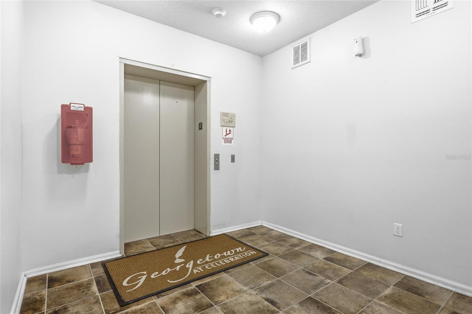 Elevator and stairs in building. - 315 GRAND MAGNOLIA AVE #312, CELEBRATION