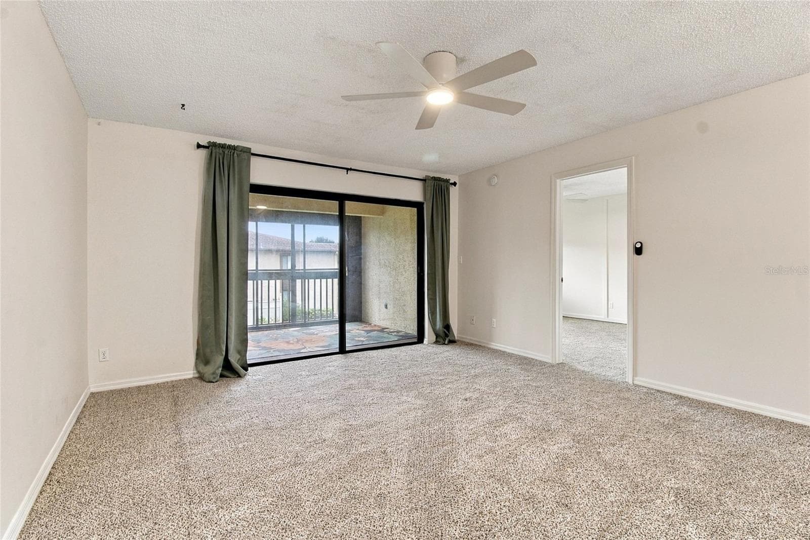 Living Area, Primary Bedroom Entrance and Entrance to Balcony - 721 83RD AVE N #202, ST PETERSBURG