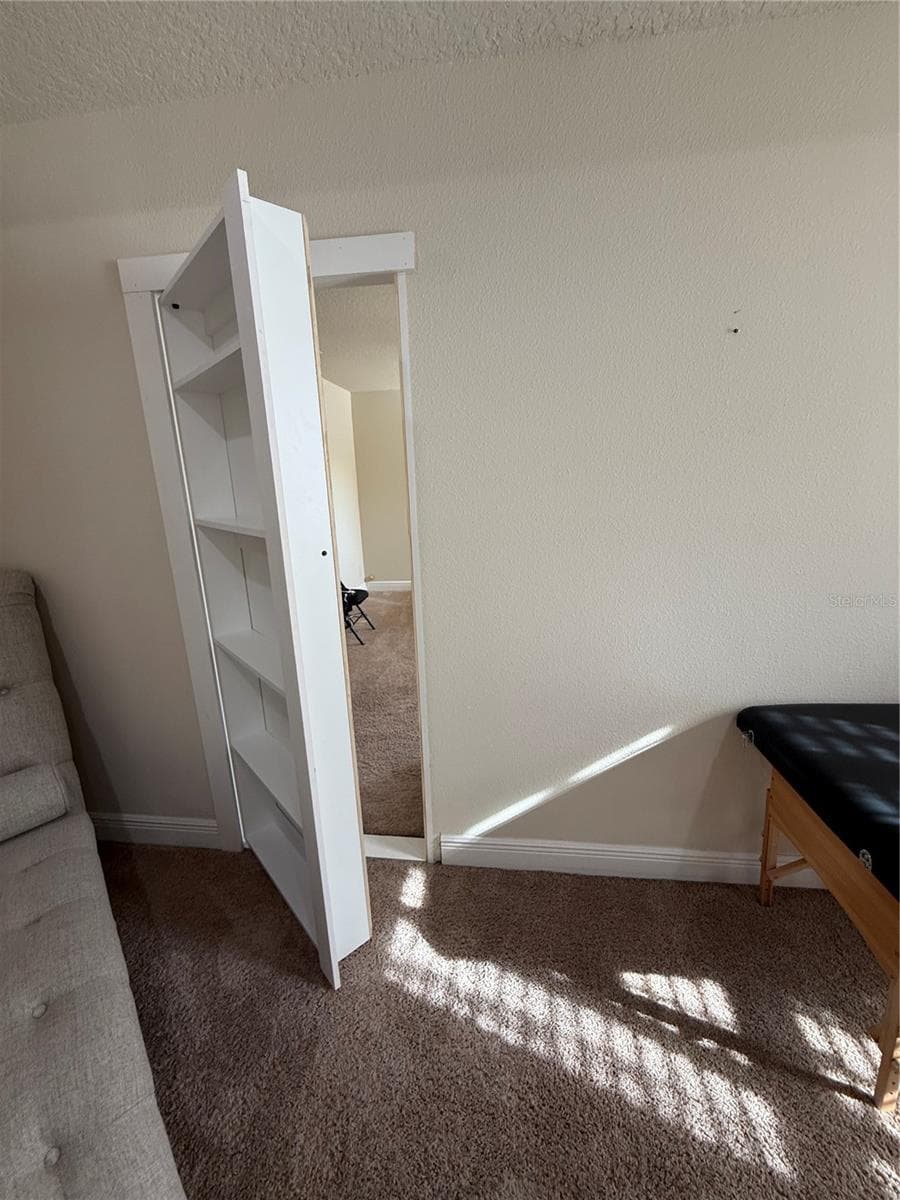 Hidden Bookshelf in Primary Bedroom leading to Bedroom 4 - 1340 LAKE BATON DR, DELTONA