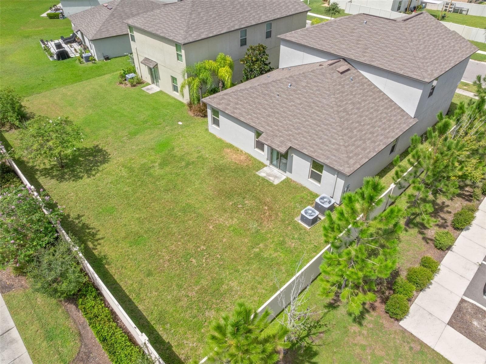 The aerial view really shows off the size of the backyard, with a broad open lawn, privacy fencing and plenty of room for a future pool, patio, play area or other outdoor living features. - 5061 WHITE CHICORY DR, APOLLO BEACH