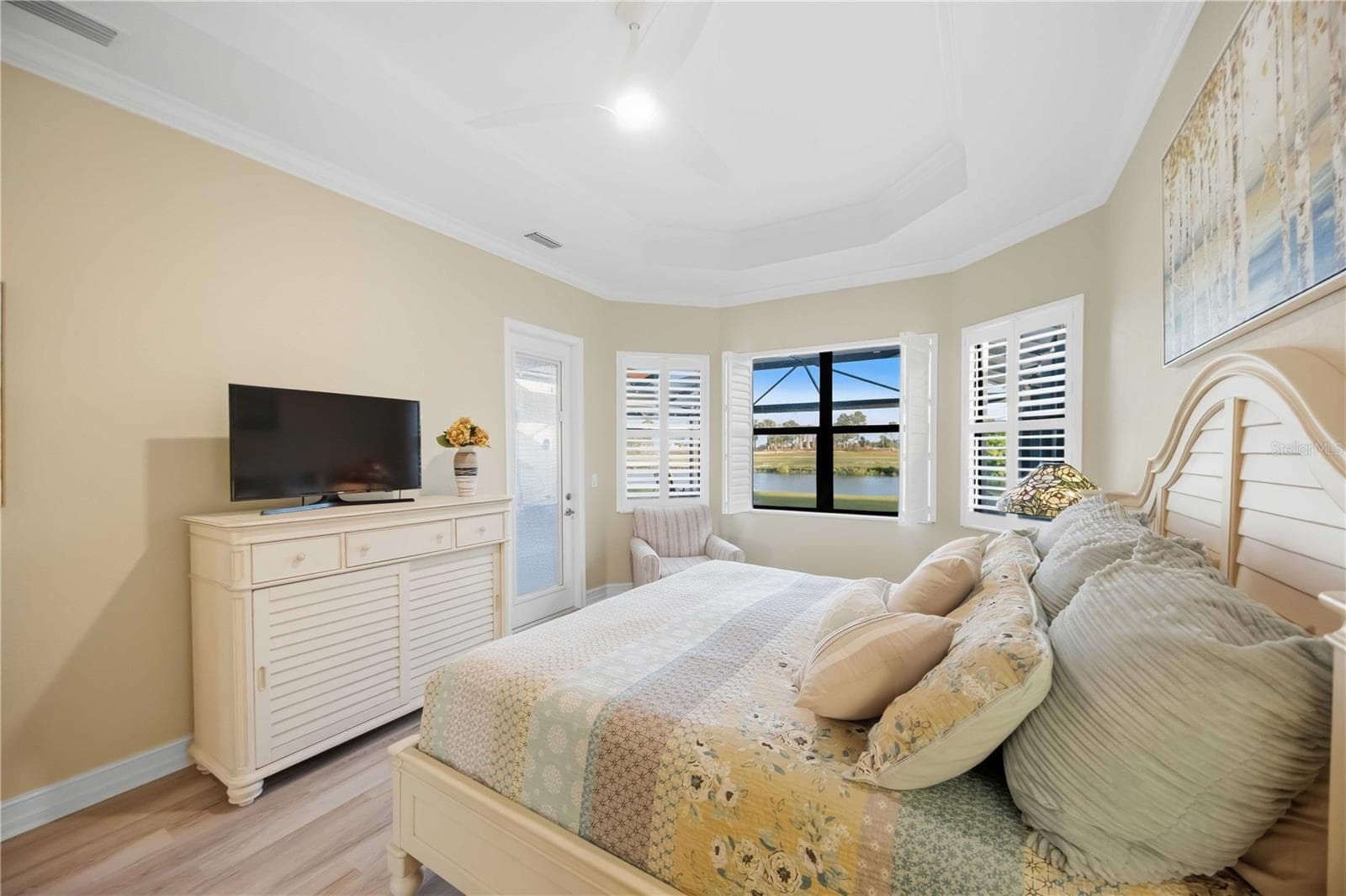 Primary Bedroom with entry to the lanai overlookiing the pool/spa - 10720 TARFLOWER DR, VENICE