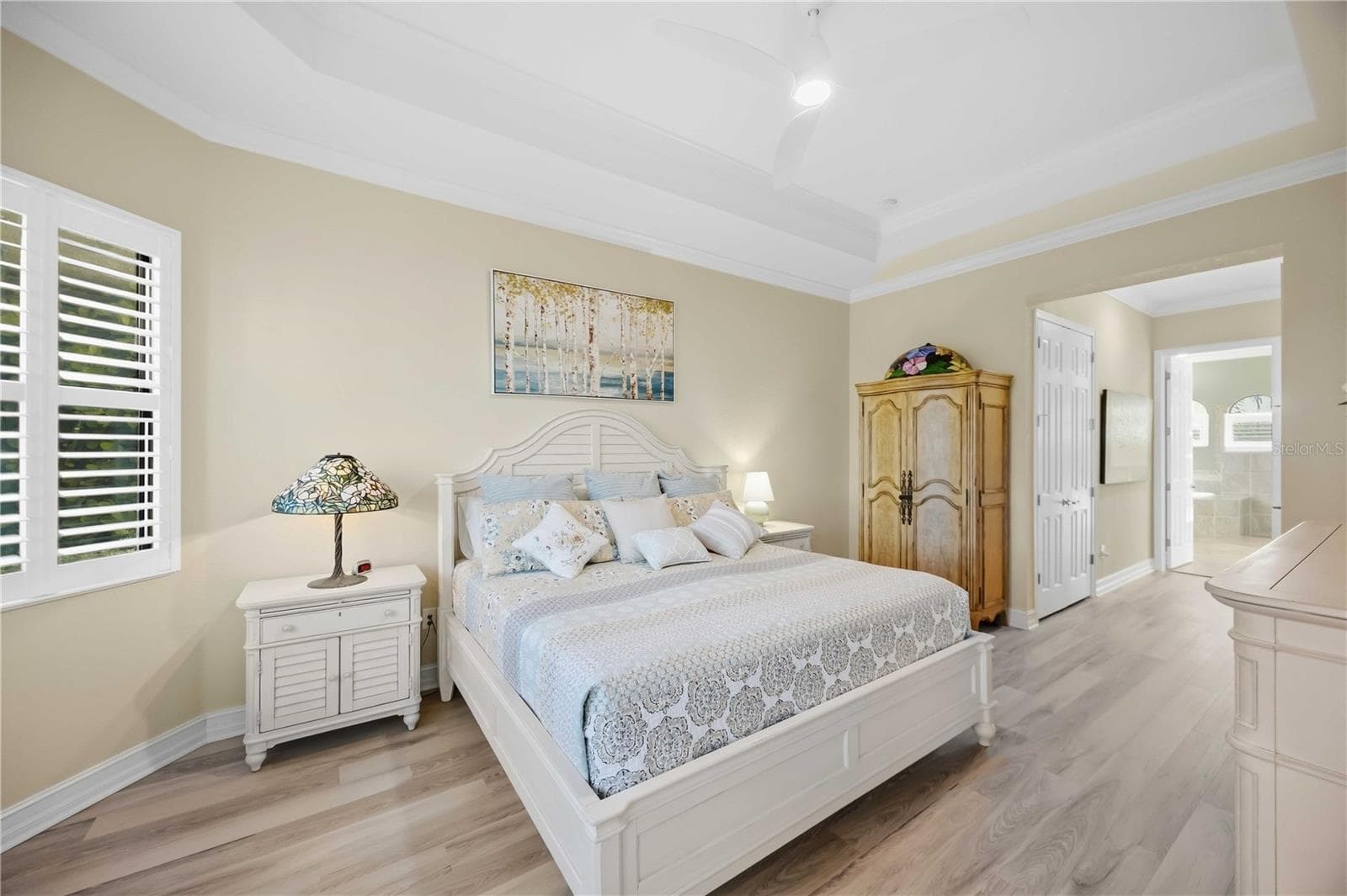 Primary Bedroom with entry to the lanai overlookiing the pool/spa - 10720 TARFLOWER DR, VENICE