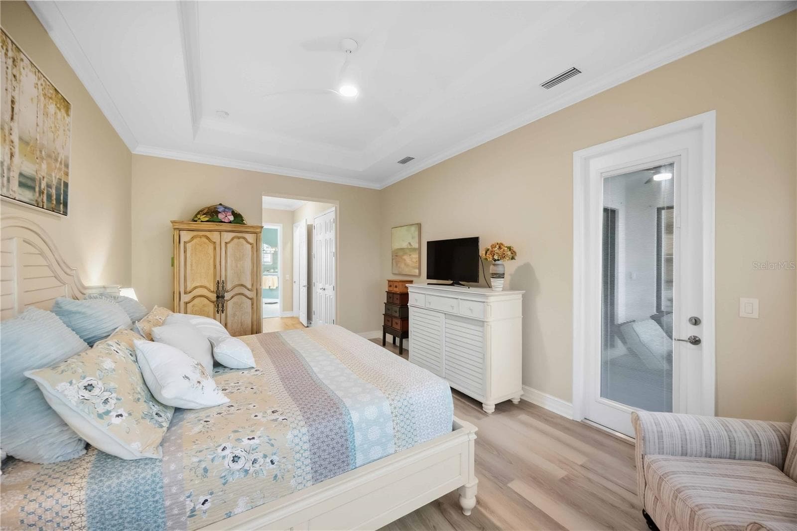 Primary Bedroom with entry to the lanai overlookiing the pool/spa - 10720 TARFLOWER DR, VENICE