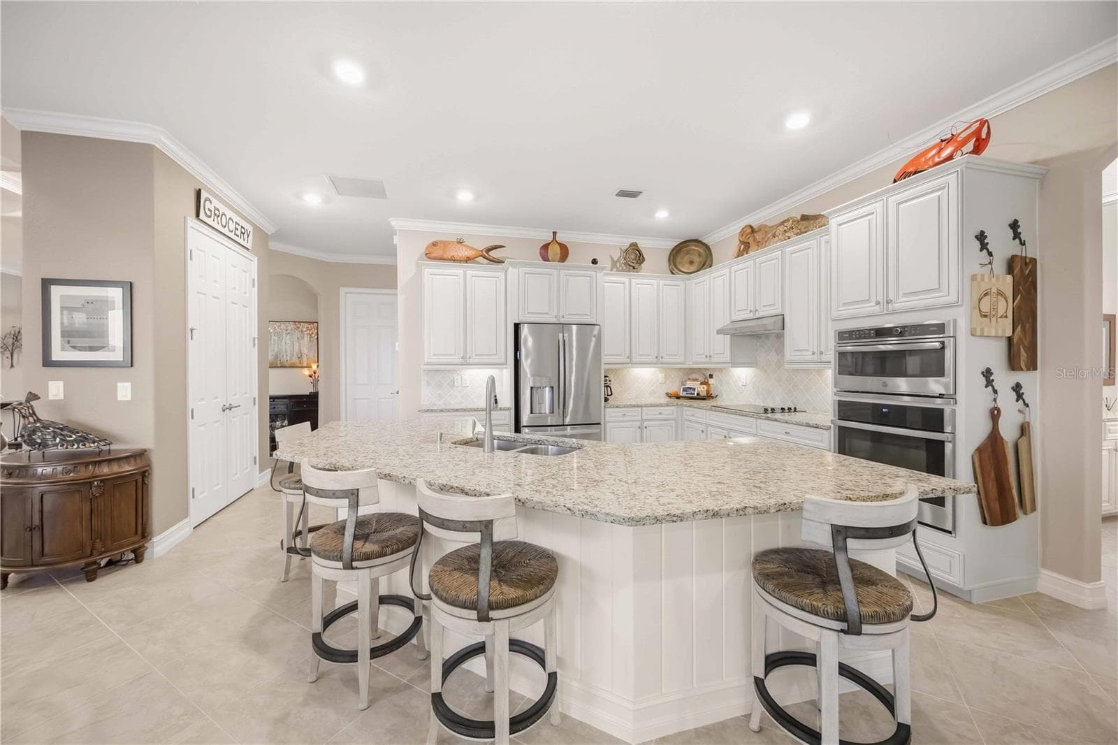 Upscale Kitchen with double ovens, dishwasher, cooktop, plenty of counter space, and dining on the counter. - 10720 TARFLOWER DR, VENICE