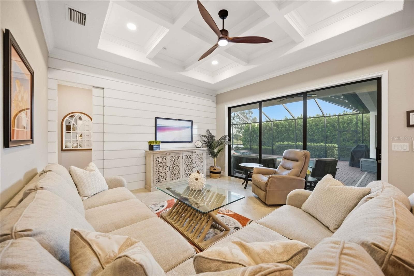 Fabulous great room with feature wall and architectural grid ceiling. Sliders to the lanai - 10720 TARFLOWER DR, VENICE