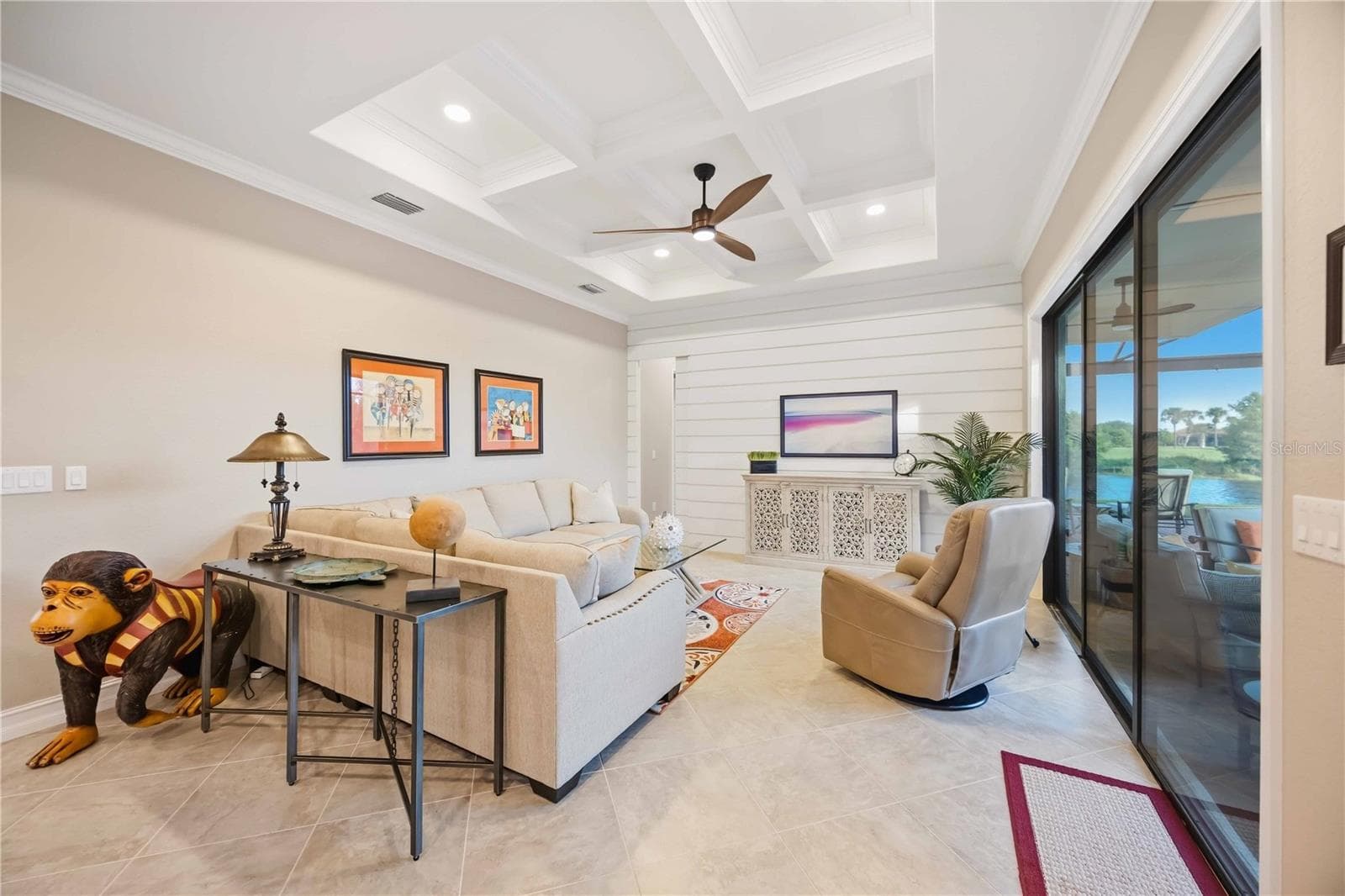The grid ceiling is custom-made, as is the shiplap wall. The shiplap wall has a hidden pocket door to go into the guest room/bath at the back of the home. - 10720 TARFLOWER DR, VENICE