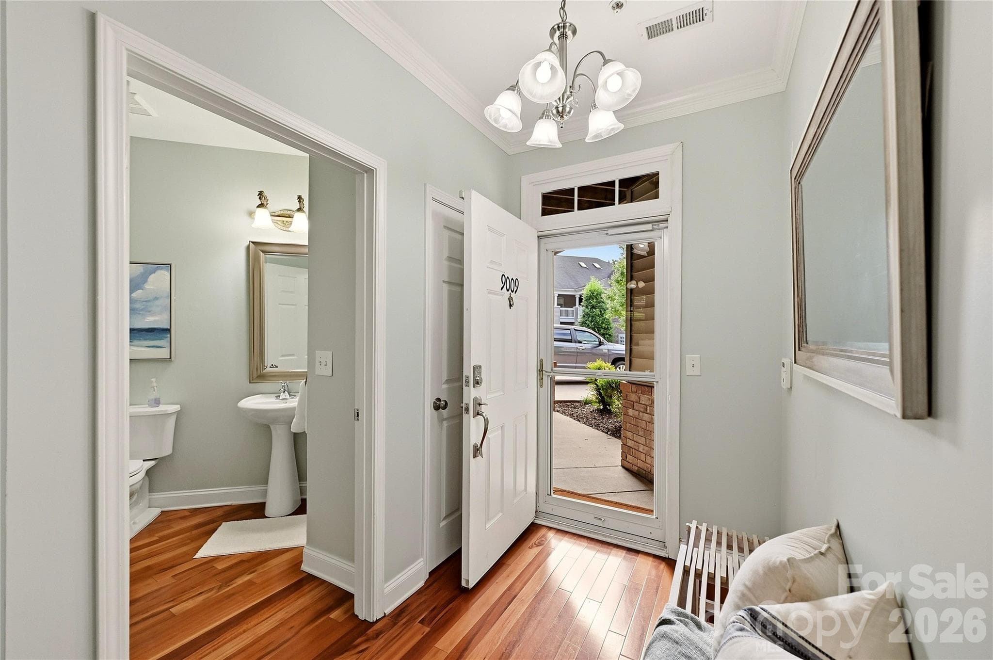 Spacious entry hall showcases hardwood flooring and easy access to the home's main living areas and bedrooms. - 9009 Rosalyn Glen Road, Cornelius