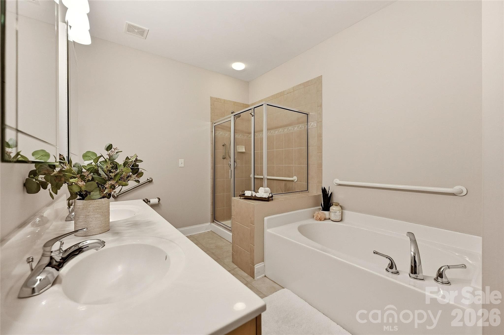 Additional primary bath view highlights the separate shower, garden tub, dual vanity, and accessibility features. - 9009 Rosalyn Glen Road, Cornelius