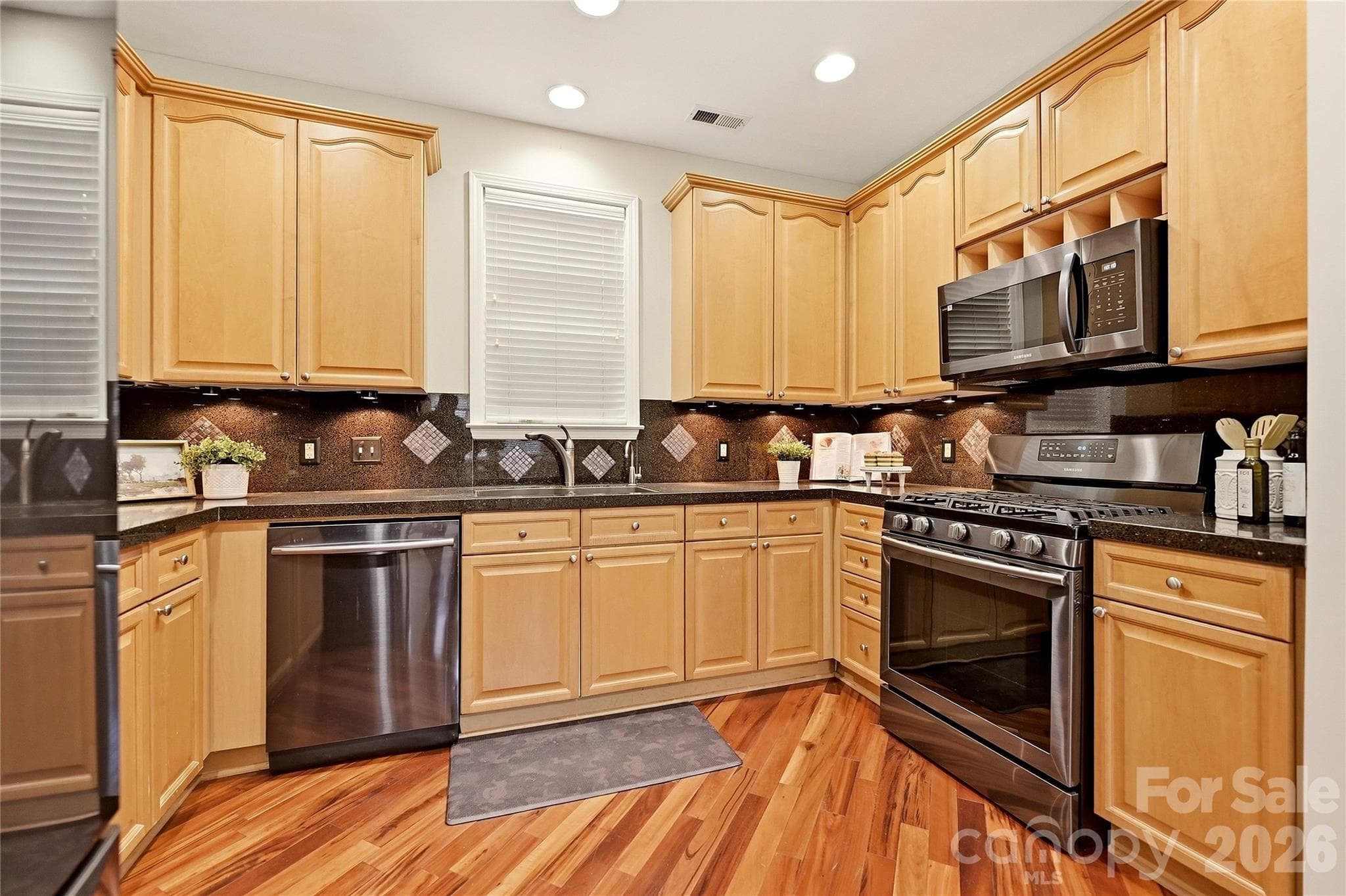 Functional kitchen provides generous workspace, stainless steel appliances, and a layout designed for everyday convenience. - 9009 Rosalyn Glen Road, Cornelius