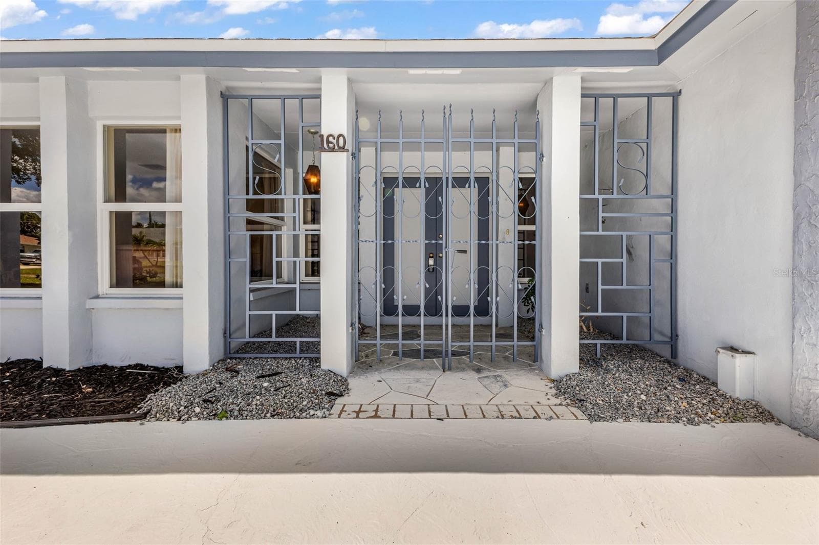 Private gated entry way to your courtyard and double entry doorway. - 160 ANNAPOLIS LN, ROTONDA WEST