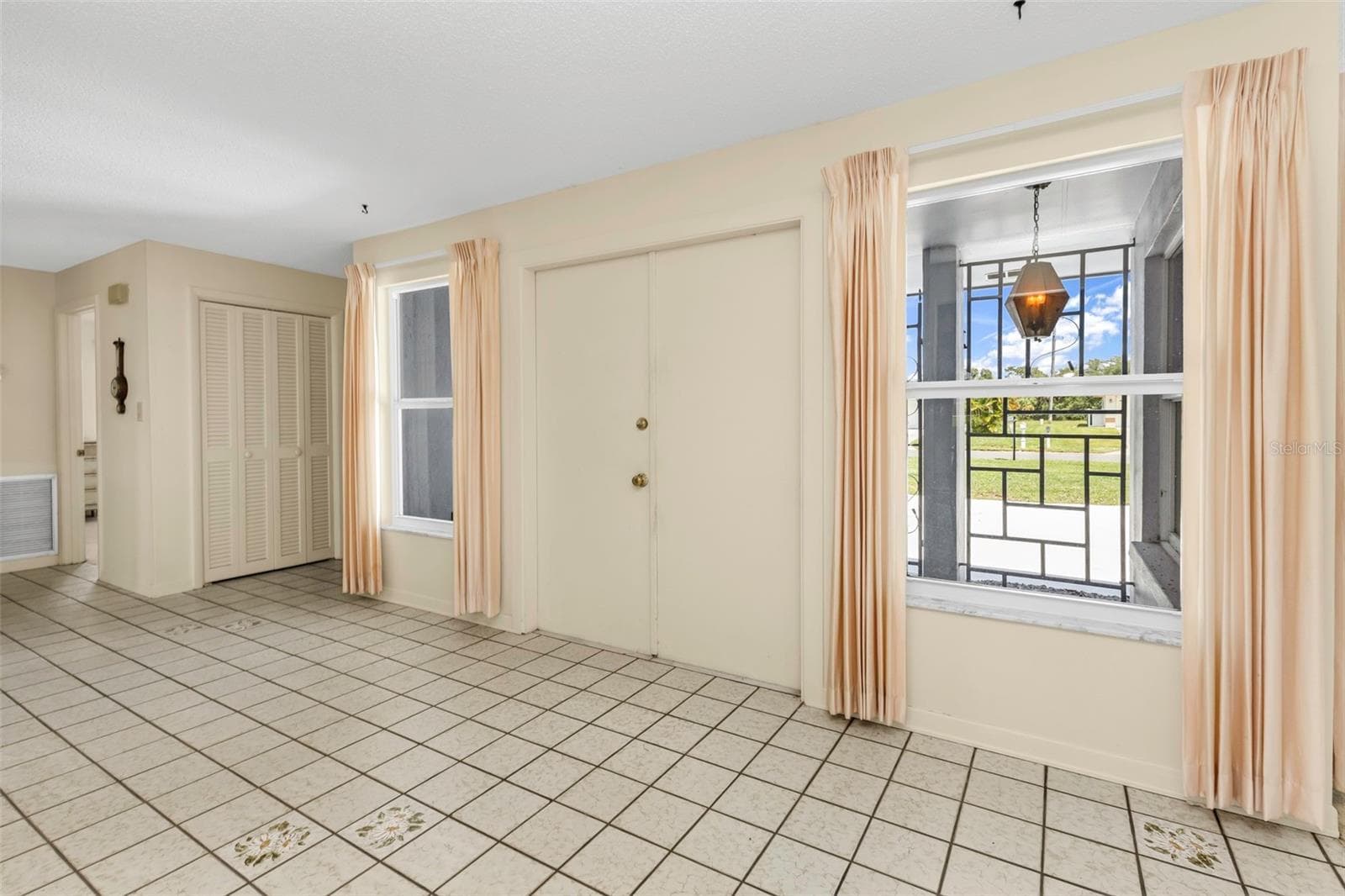 Entry way to the house through double doors, side entry to garage and laundry room, plus hallway closet/storage space and hallway bathroom. - 160 ANNAPOLIS LN, ROTONDA WEST