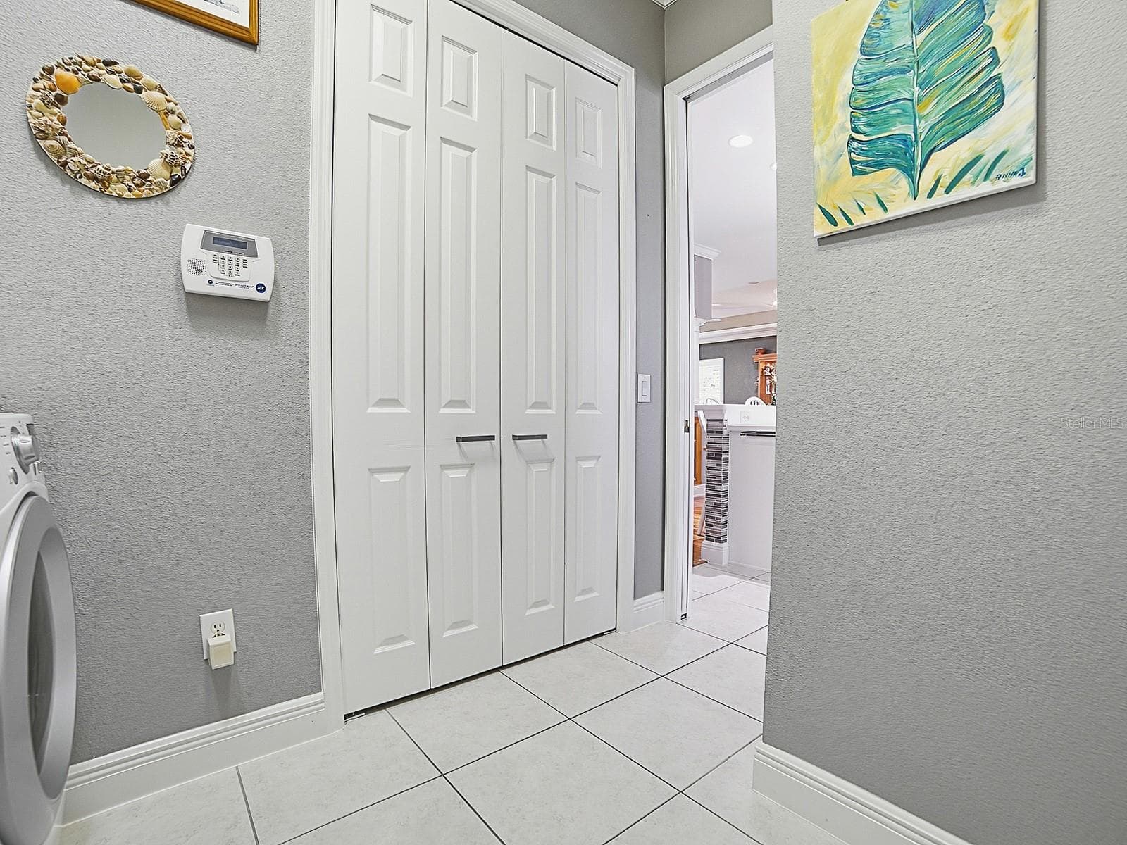 ANOTHER LARGER DOUBLE DOOR PANTRY ADDED TO THE LAUNDRY ROOM. SO MUCH STORAGE SPACE RARELY FOUND EVEN IN PREMIER HOMES. - 1897 HARTFORD PATH, THE VILLAGES