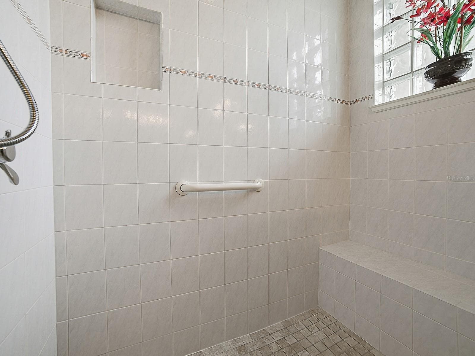 SPACIOUS TILED SHOWER WITH A BENCH. - 1897 HARTFORD PATH, THE VILLAGES