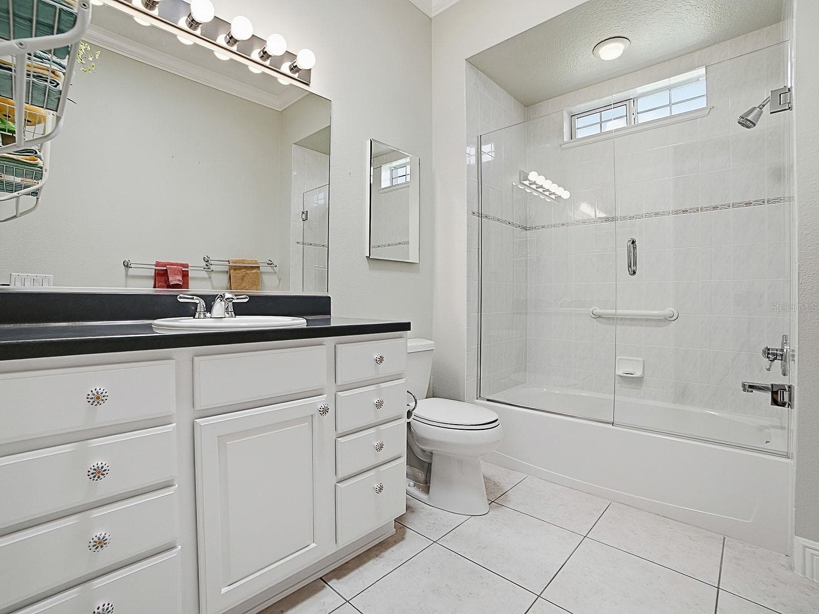 THE GUEST BATHROOM HAS A FRAMELESS GLASS ENCLOSURE ON THE TUB/SHOWER. - 1897 HARTFORD PATH, THE VILLAGES