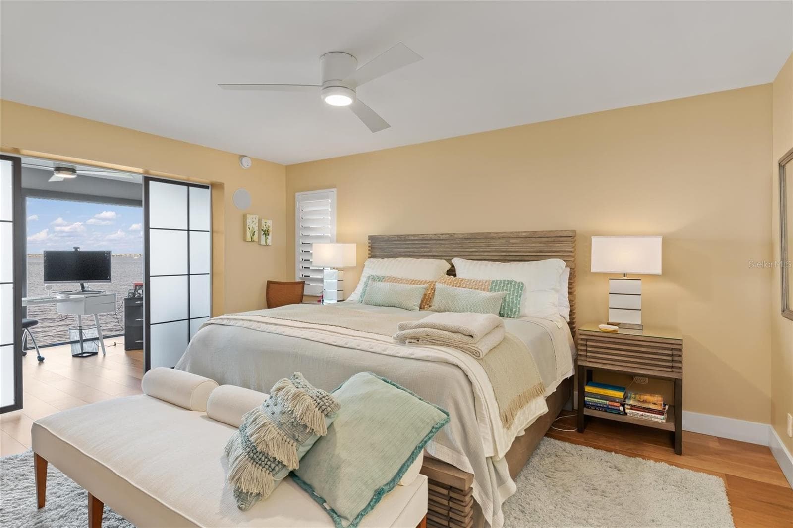 Master bedroom with translucent glass barn doors - 1600 W MARION AVE #224, PUNTA GORDA