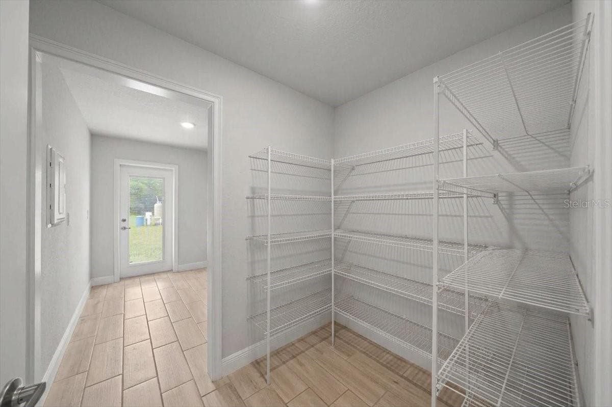 Pantry and Laundry room w/door to back yard - 140 NW 113TH CIR, OCALA
