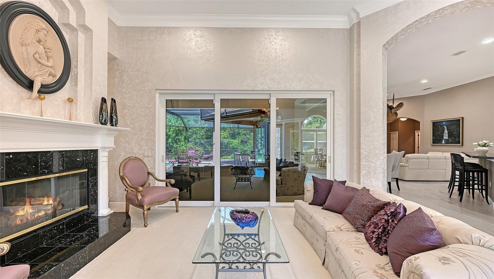 Separate Living Room with decorative natural gas fireplace. - 8866 BLOOMFIELD BLVD, SARASOTA