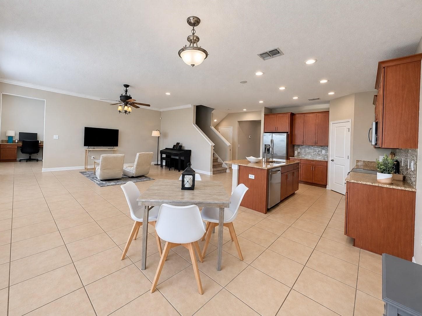 Open-concept kitchen and living area creates an easy flow for gathering and entertaining. - 1516 BUNKER DR, DAVENPORT