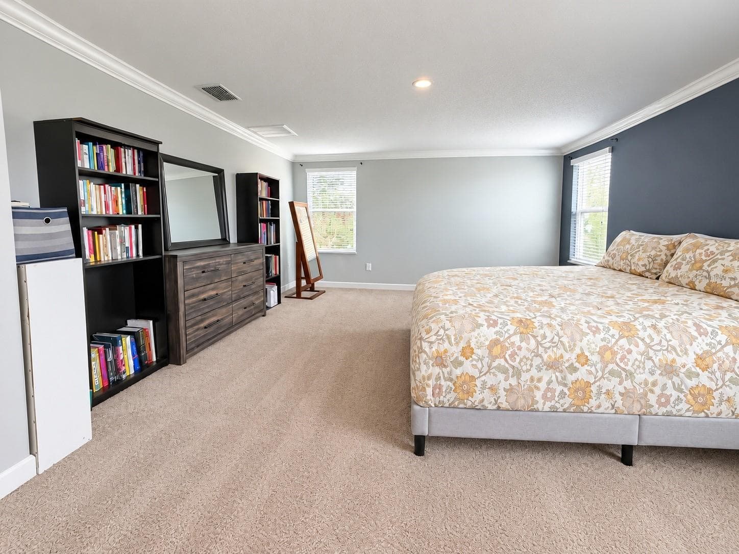 Spacious primary bedroom featuring abundant natural light and a large walk-in his and hers closet. - 1516 BUNKER DR, DAVENPORT