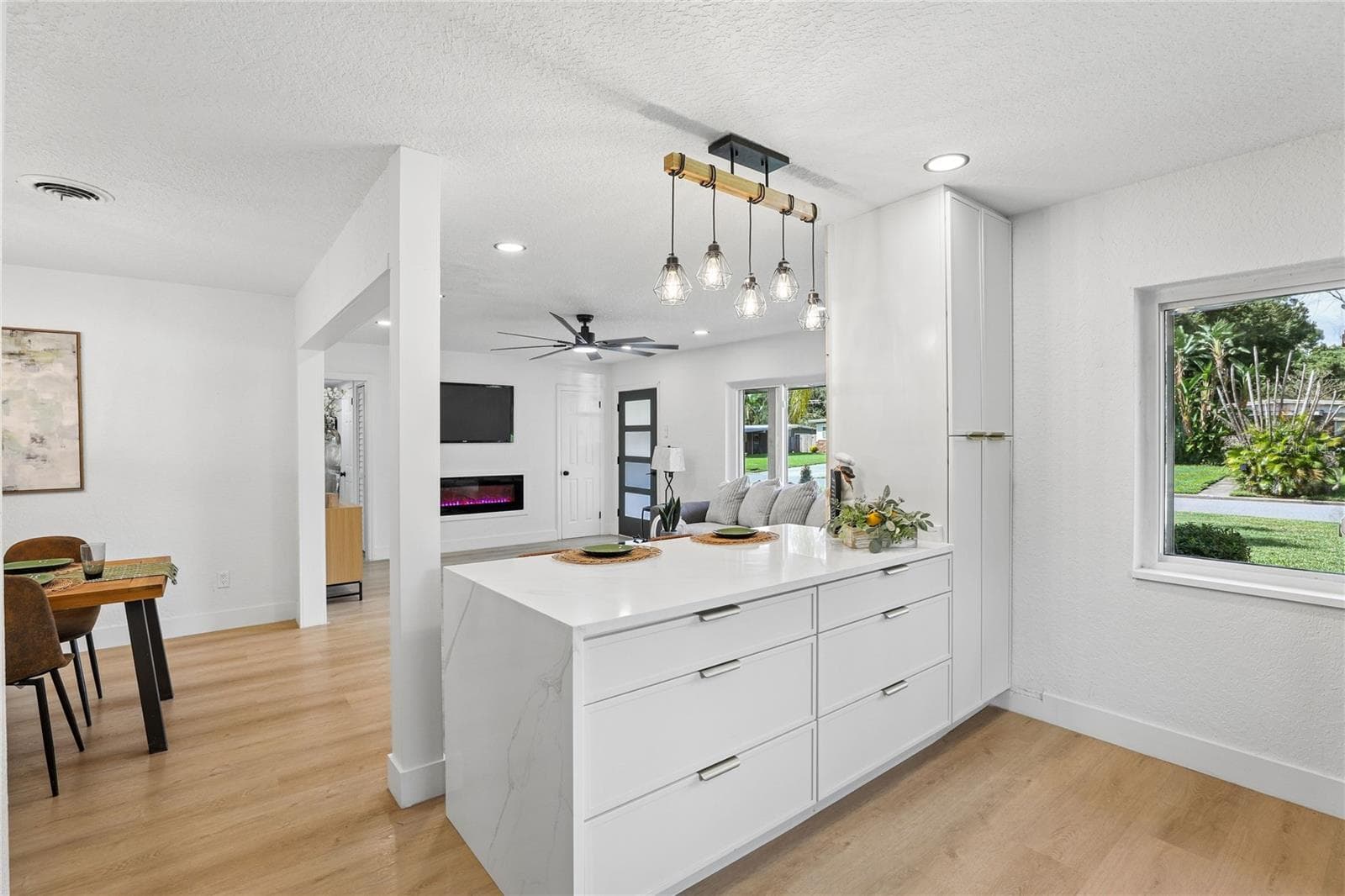 The heart of the home — redesigned kitchen with waterfall-edge island - 1718 CAMPBELL AVE, ORLANDO