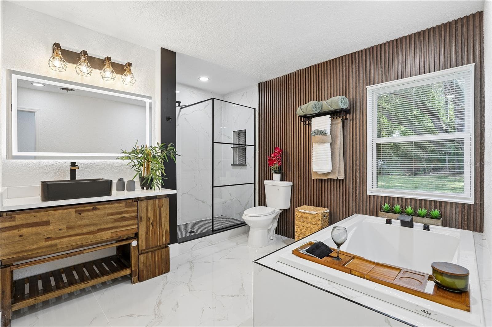 Spa-inspired primary bath with soaking tub and custom wood accent wall - 1718 CAMPBELL AVE, ORLANDO