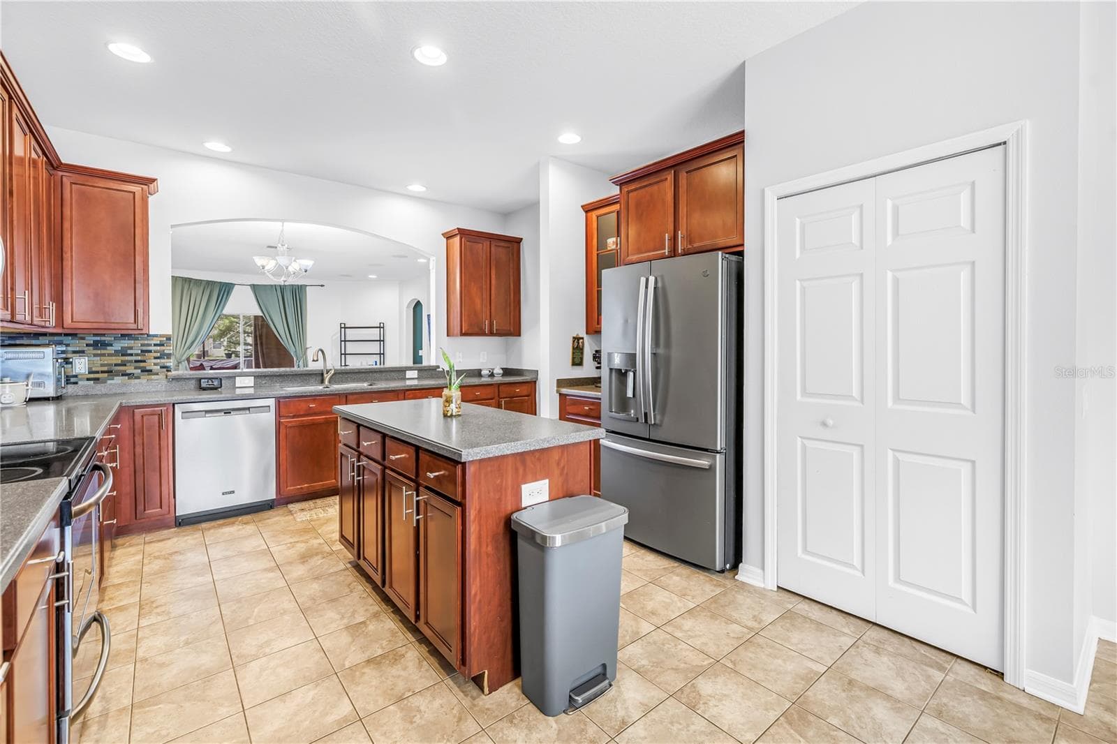 Kitchen With Island and View Into Living Area - 7717 TANGLE BROOK BLVD, GIBSONTON