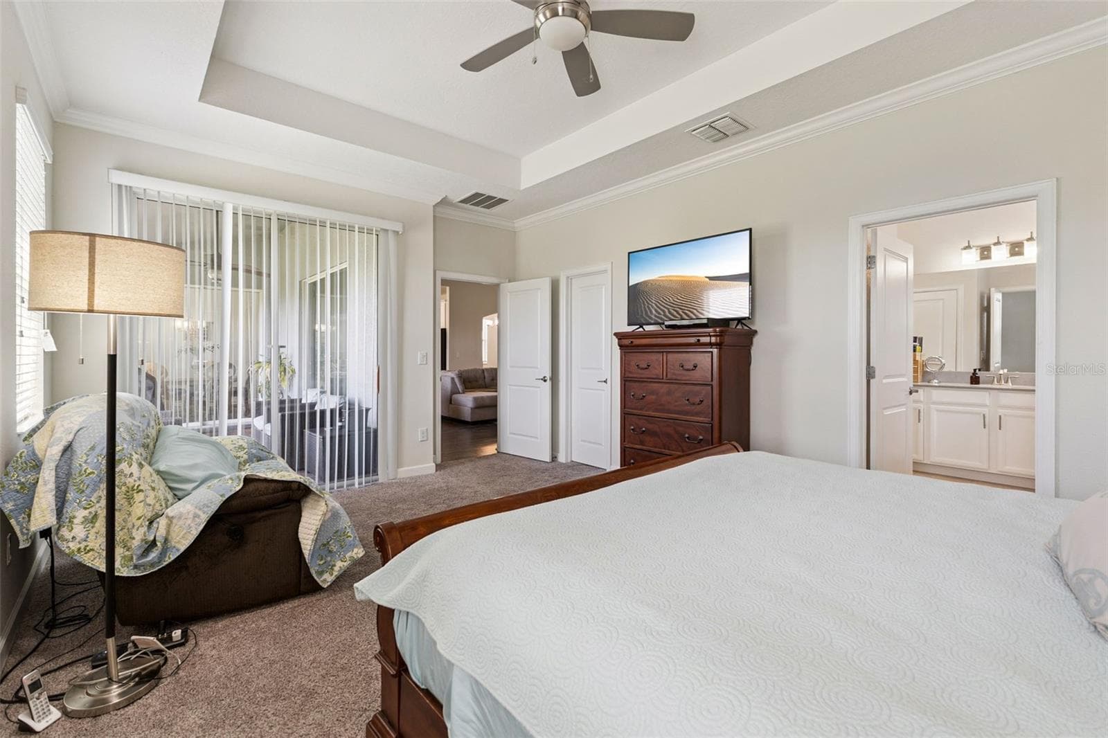 Primary Bedroom offers a Large Walk-in Closet and Sliding Glass Doors to the Lanai - 4075 BEDFORD AVE, WINTER HAVEN