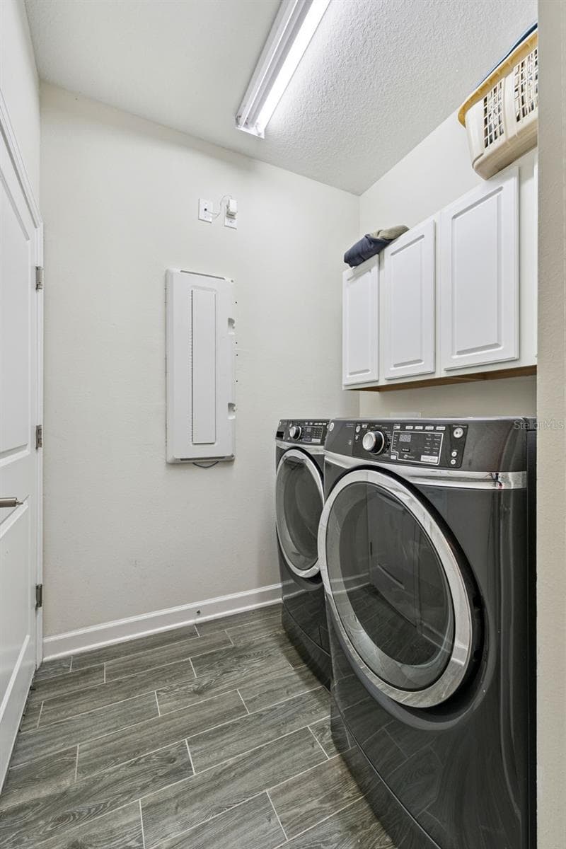 Laundry Room with cabinetry, washer and dryer - 4075 BEDFORD AVE, WINTER HAVEN