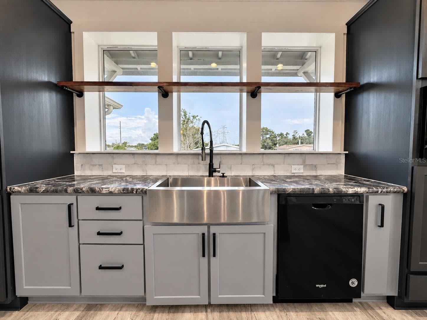 Farm sink under the bank of windows. - 9248 SCEPTER AVE, BROOKSVILLE