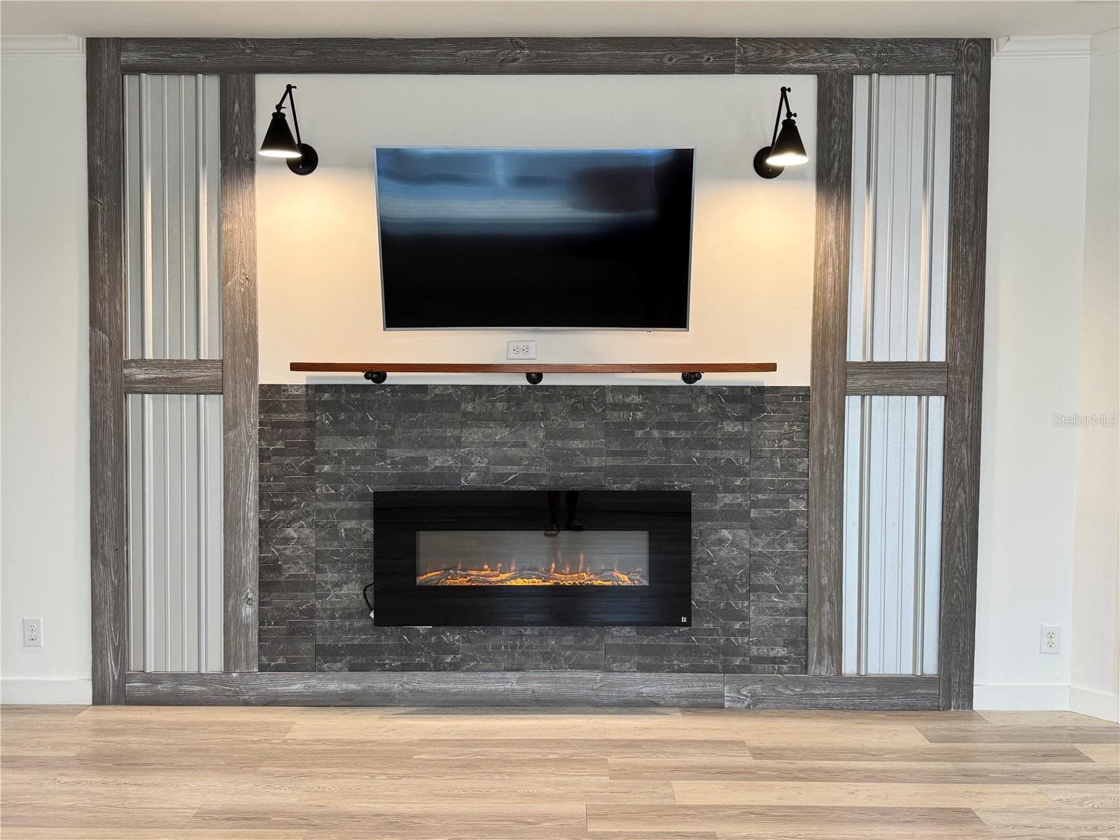 Fireplace with wall-mounted tv above it. - 9248 SCEPTER AVE, BROOKSVILLE