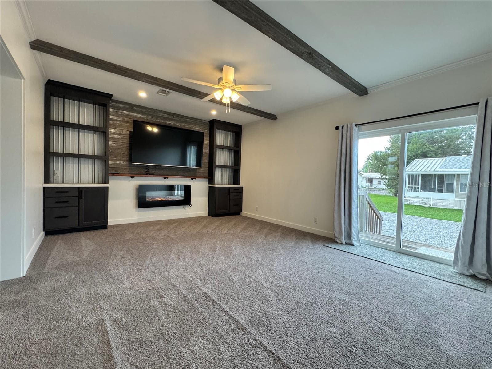 Family room with sliding glass doors to the rear part of the yard. - 9248 SCEPTER AVE, BROOKSVILLE