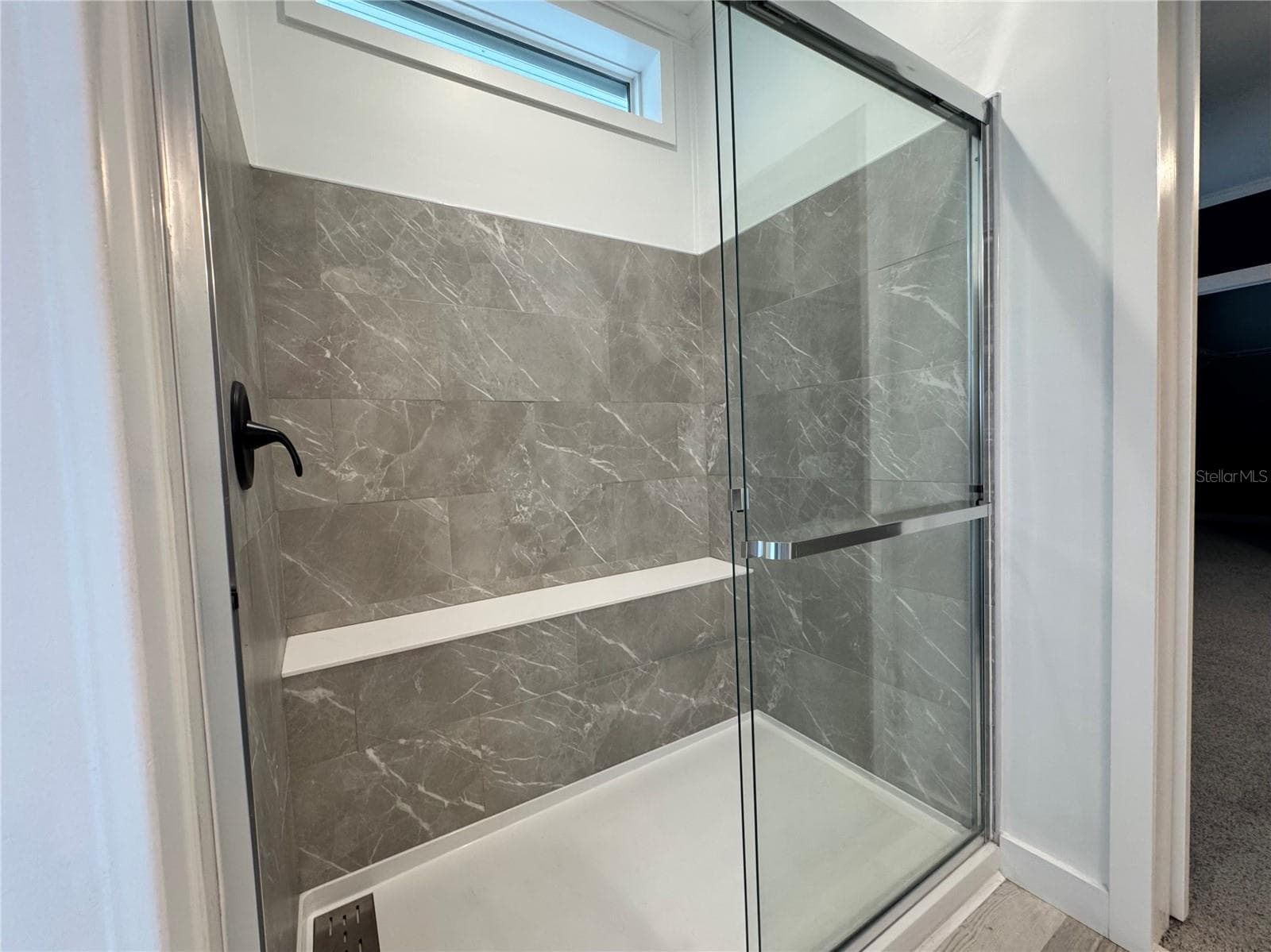 Primary shower with bench. - 9248 SCEPTER AVE, BROOKSVILLE