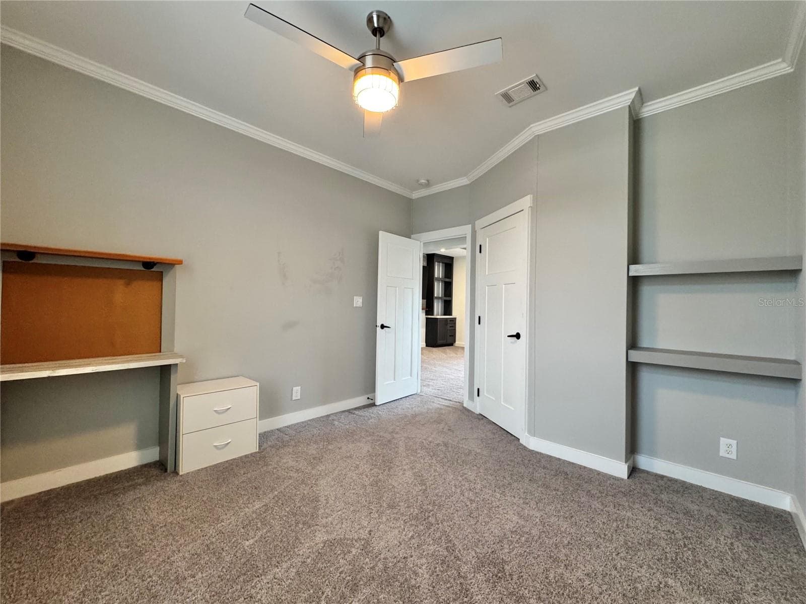 Bedroom 2 with built-in shelves and walk-in closet. - 9248 SCEPTER AVE, BROOKSVILLE