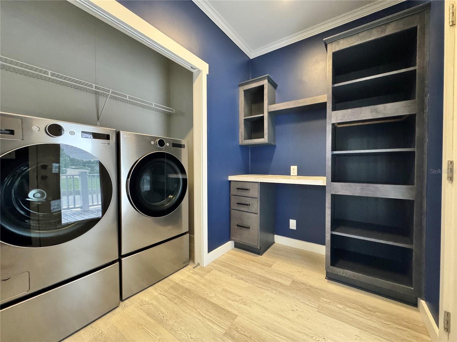 Laundry room with built-in desk and shelves. - 9248 SCEPTER AVE, BROOKSVILLE
