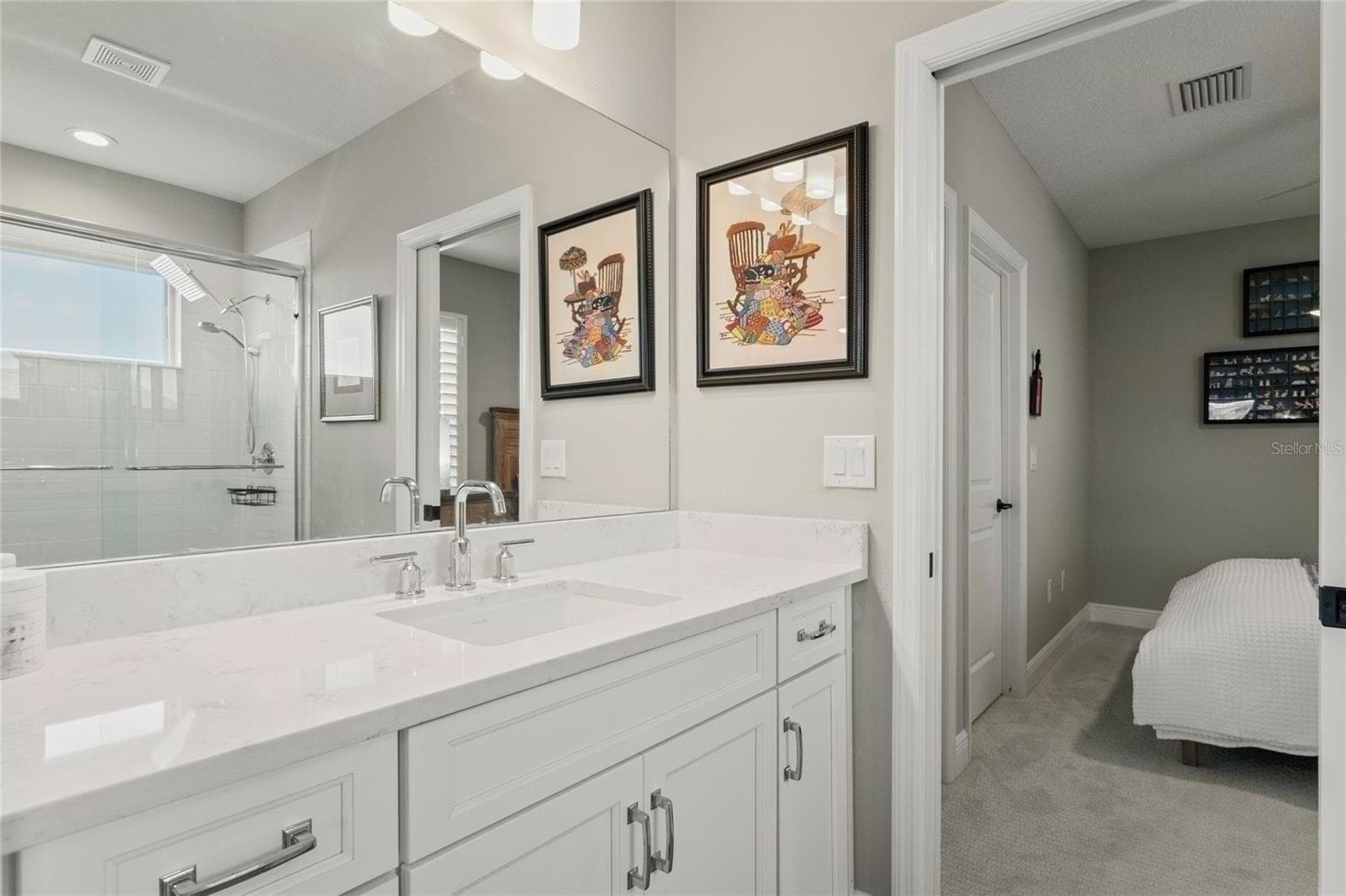 Upstairs Jack-and-Jill bathroom, with marble-style countertops, modern fixtures, and direct access between the loft and bonus bedroom. - 10625 FALLING LEAF CT, PARRISH